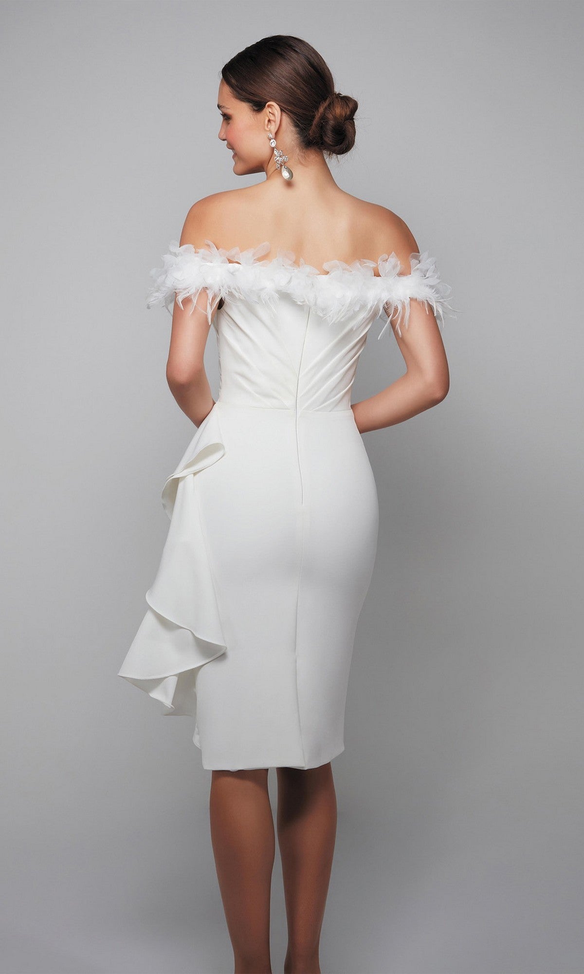 A woman wearing the Alyce 70000 knee-length semi-formal dress with off-the-shoulder style, feather trim, and a side ruffle stands against a plain gray background, her back facing the camera.